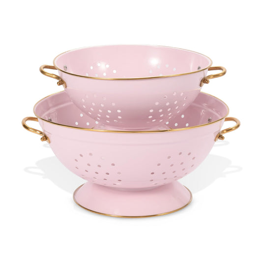 Two pink colanders with gold handles on a white background