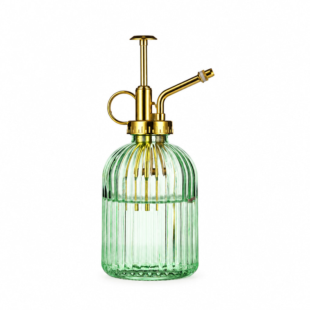 Green glass bottle with gold metal sprayer