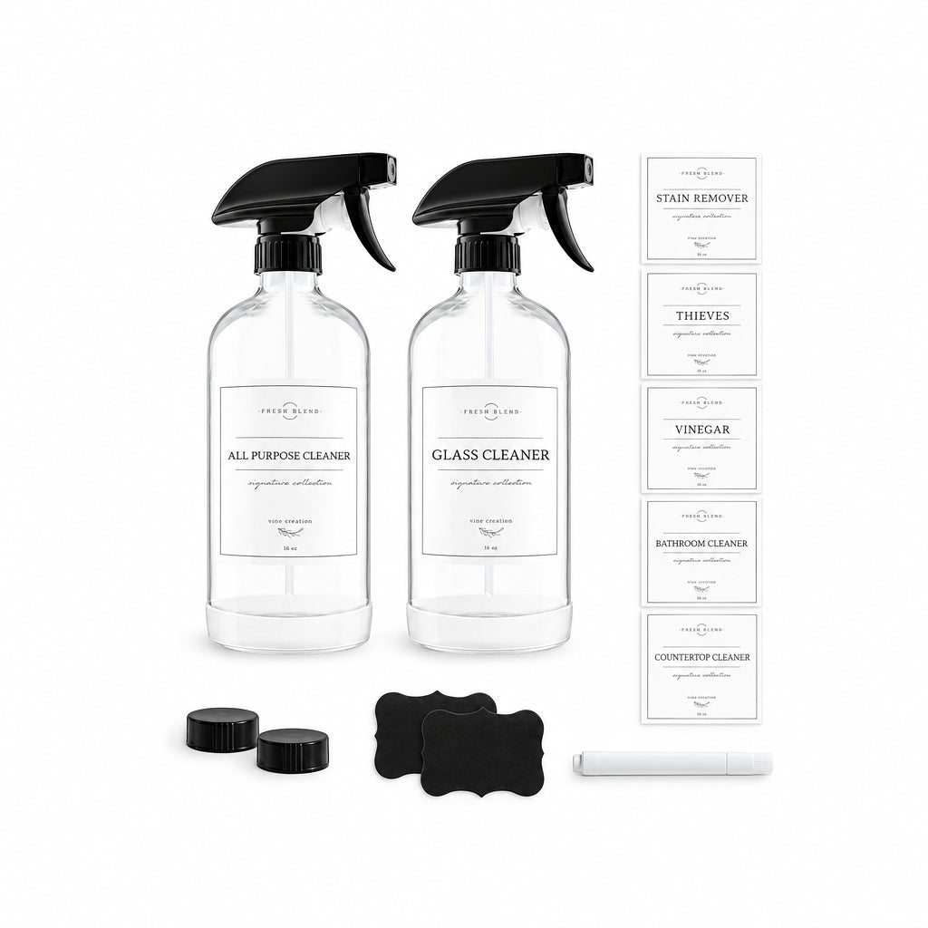 Two clear spray bottles with black triggers labeled 'ALL PURPOSE CLEANER' and 'GLASS CLEANER' on a white background, alongside several white label sheets, two black cloths, and a white brush. Brand text 'Fresh Blend' is visible on the labels.