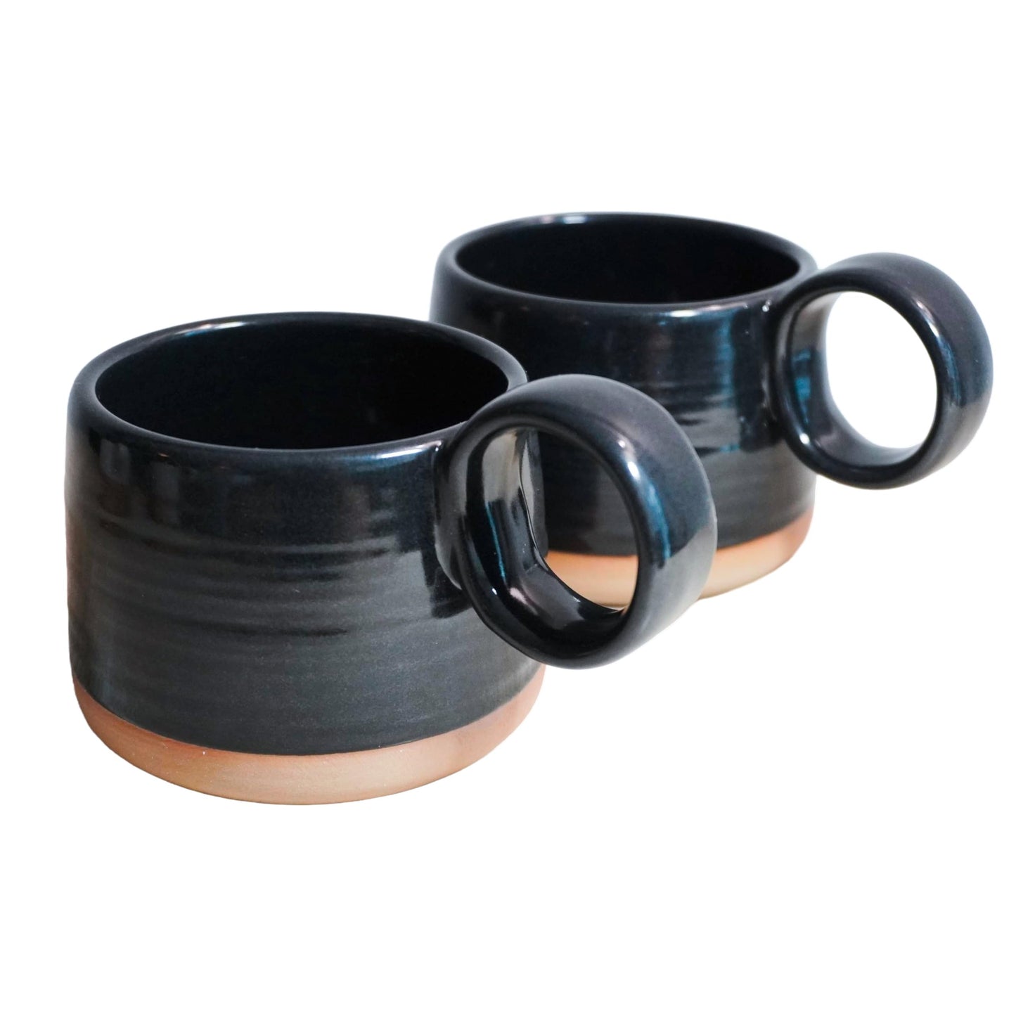 Two black ceramic mugs with brown bases on a white background