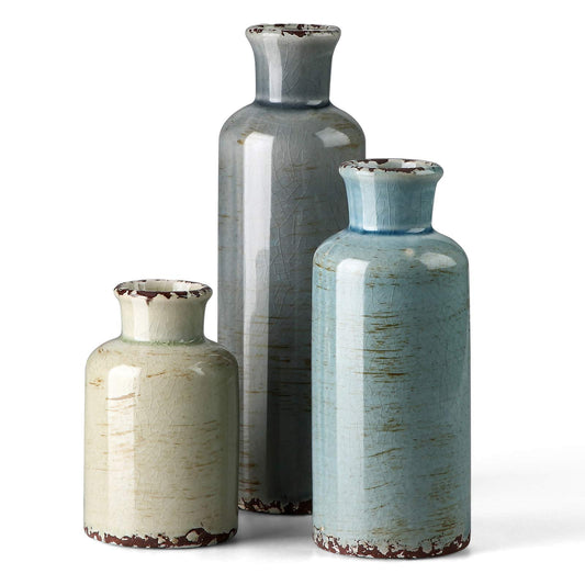 Three ceramic vases with textured surfaces on a white background