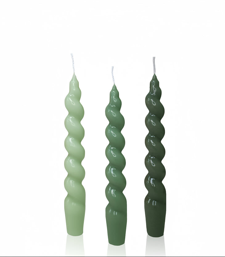 Green spiral candles with a box labeled 'SSY Taper Candles' on a white background