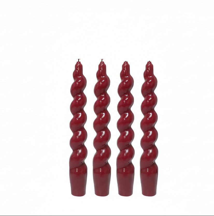 Red twisted taper candles with a box labeled 'SSY Taper Candles' on a white background